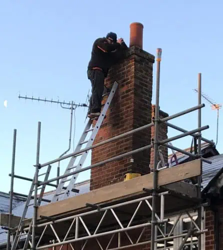 Photo showing JBL chimney services inspecting a chimney in Surrey
